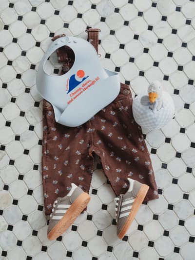 Ron Herman Kids Baby Gift Picks Include a Silicone Bib, Coveralls, and a OneLuck Collaboration Set