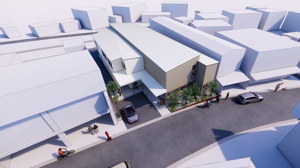 The hostel as seen from above, with a modern roof shape defined by sharp angles and straight lines inspired by the morning market tents of Mutsu-Minato.
