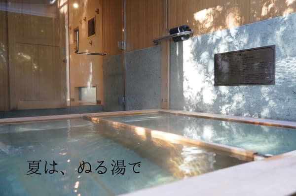 Guests relaxing in samue after onsen bathing at the fireside BBQ