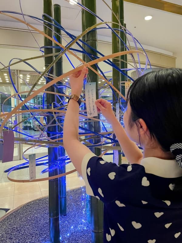 Guests write wishes on tanzaku strips to add to the display
