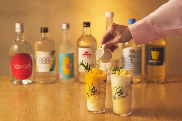 Pouring the chosen awamori to finish the cocktail