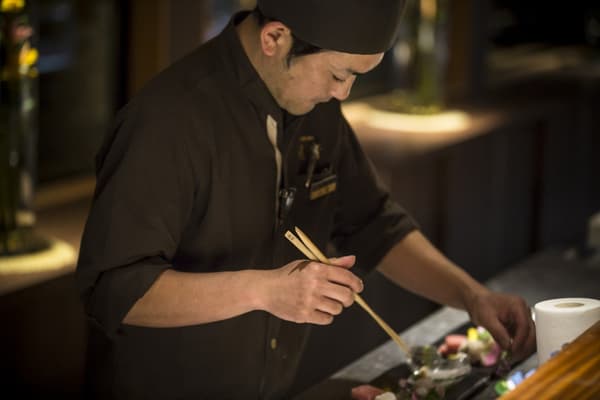 A chef finishing a dish tableside