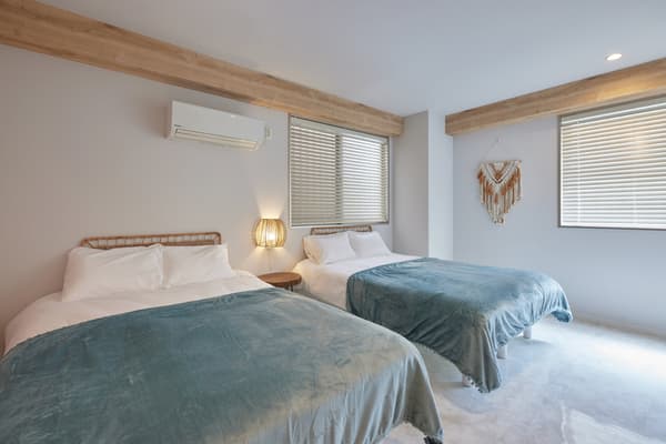 Main bedroom with soft blue accents and natural light