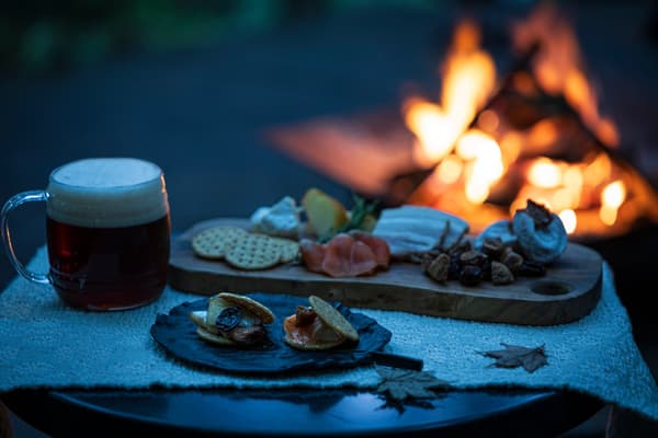 Deer pâté and dried fruit grilled over a campfire fueled by peach wood
