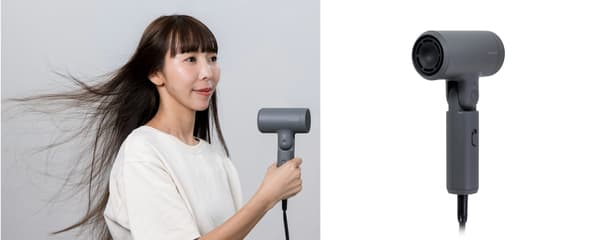 A woman using the hair dryer with a strong airflow, and the dryer's air outlet