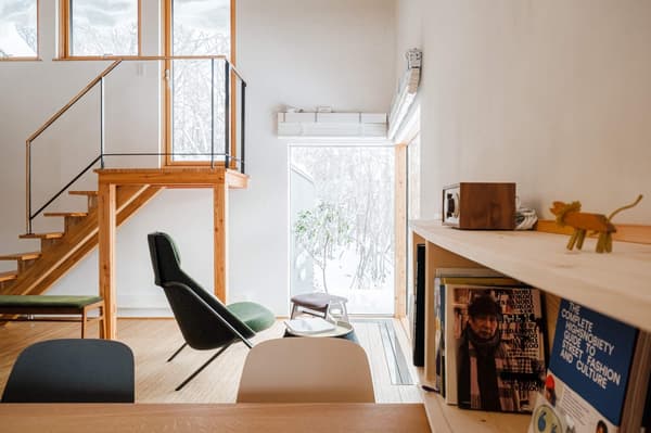 A reading nook near the staircase, with design and art books on display