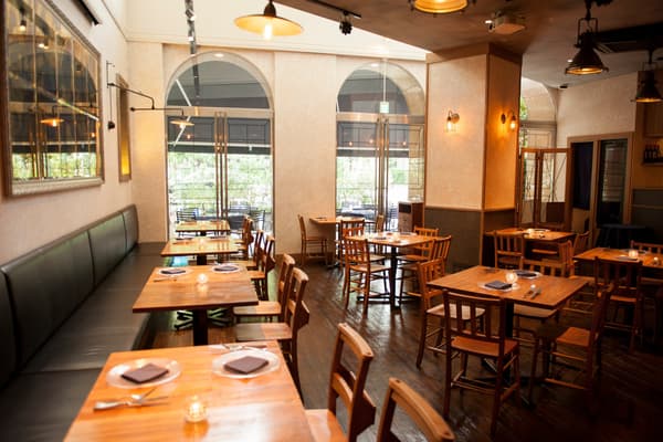 Dining room with wooden tables and arched windows