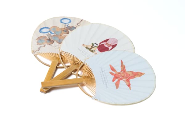 Mini fans featuring works from the collection: Morning Glories (detail) by Nakamura Hochu, Edo period; Fushimi Toys (detail) by Ito Jakuchu, Edo period; and Goldfish Ball (detail) by Kamizaka Sekka, Meiji period – all from the Hosomi Museum collection