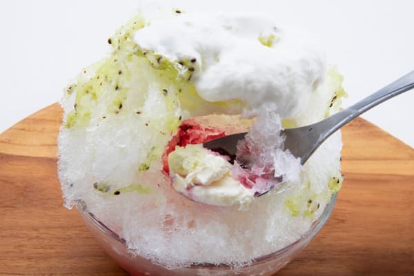Strained yogurt tucked inside, revealed as you eat your way through the kakigori
