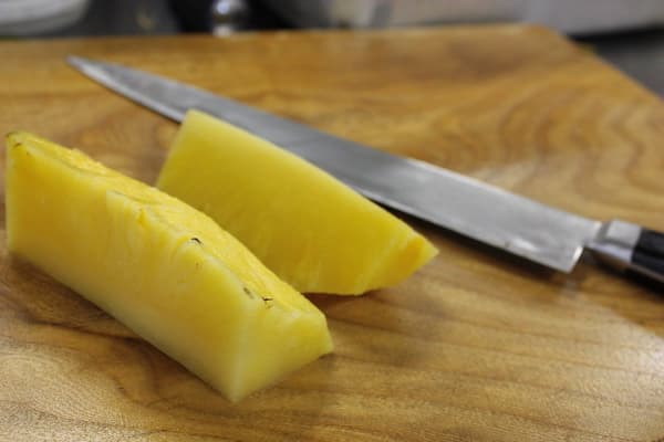 Pineapple Ale poured into a glass, showing the beer's color and foam