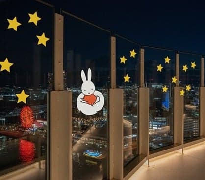 Kobe Port Tower rooftop deck with night-time Miffy and cloud designs on the glass walls