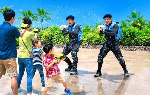 JUNGLIA OKINAWA Water Rangers dousing guests with water shooters across the park