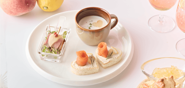 Savory plate featuring duck and white peach pinchos, chilled vichyssoise, and smoked salmon heart sandwich