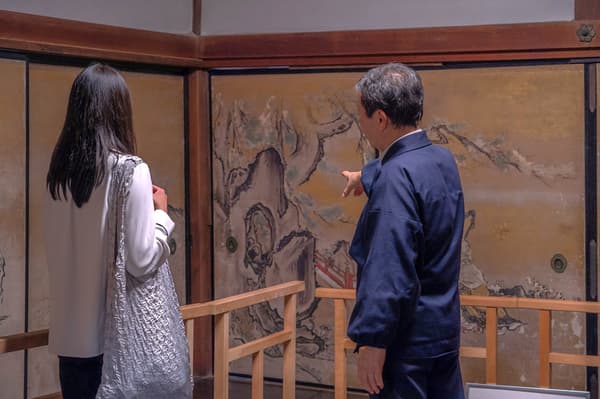 Beautiful gardens and fusuma paintings are viewed with a guide from the temple