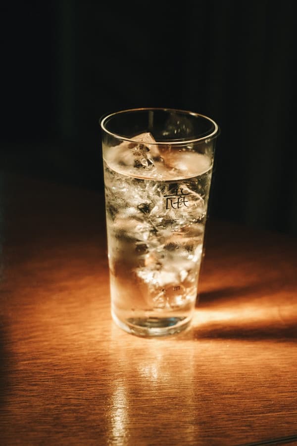 A glass of iced drink on the counter