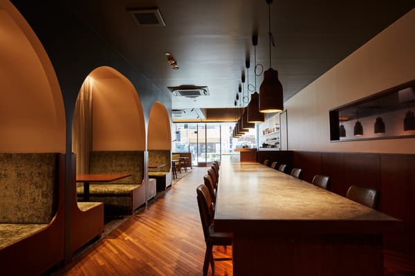 Arch-style semi-private booths reminiscent of a luxury train compartment