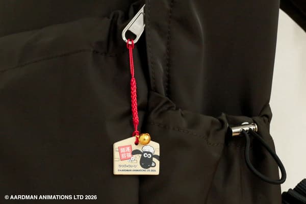 Shaun the Sheep Netsuke Ema Keychain attached to a bag