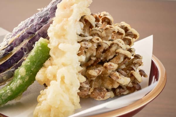 Charred shimeji mushrooms, a dish that originated at Kawagoe-ya, are a signature item.