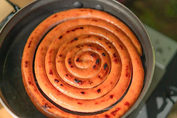 Guruguru Sausage, coiled and grilled whole