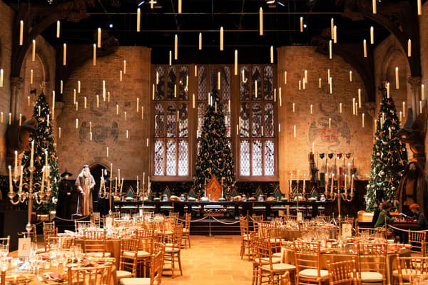 The Great Hall set for dinner with floating candles and Christmas trees