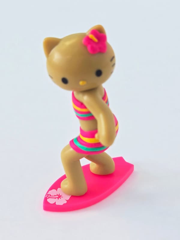 Surfer figure on surfboard-shaped base