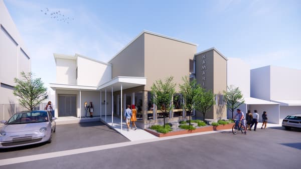 The exterior concept of KAMARI Hostel & Tours, designed to evoke the layered history and atmosphere of the port town.