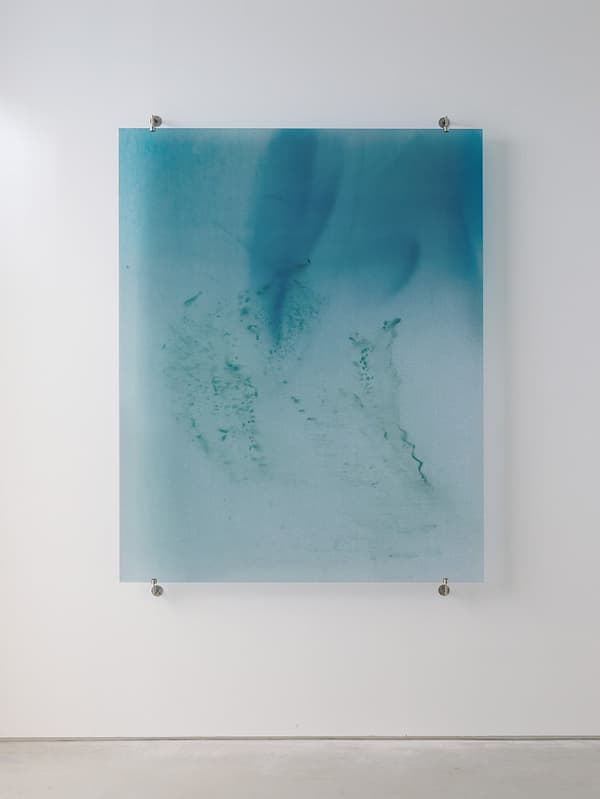Zai Nomura, *Biophotons Shine So Brightly* (woman with dwarfism wearing a white vest, smiling alone by a lake, 1981), 2026, UV inkjet print on glass with stainless steel fittings, collection of the artist
