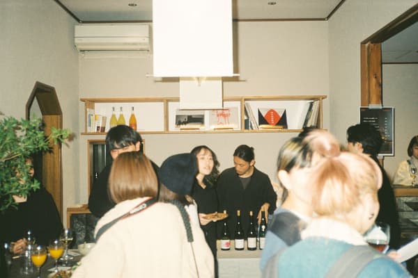 An event at C&C with guests gathered around a counter