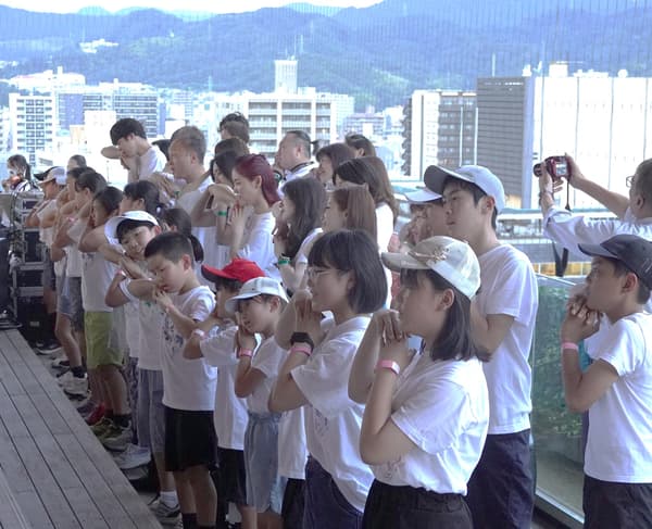 Children singing on the rooftop observatory of Orizuru Tower