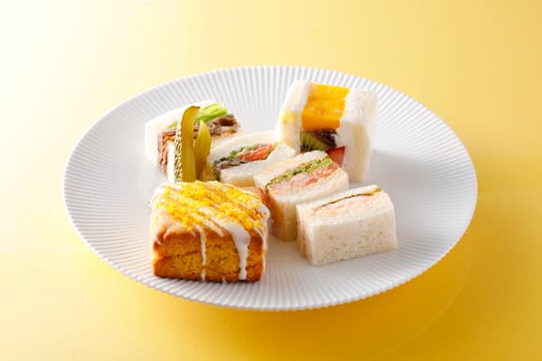 Fruit sandwiches and other savory items on the bottom tier