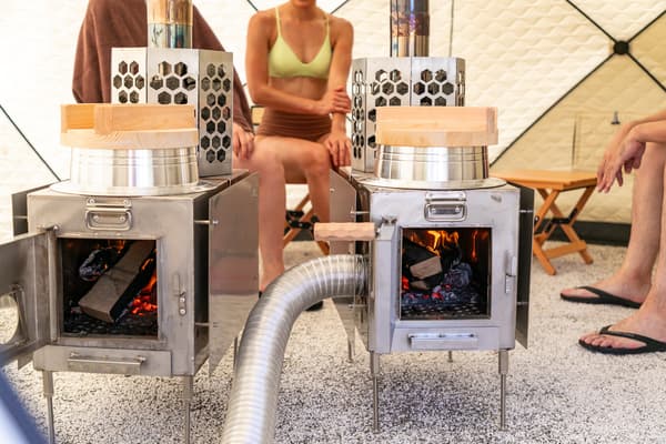 Wood-burning stoves inside the dome-shaped tent sauna