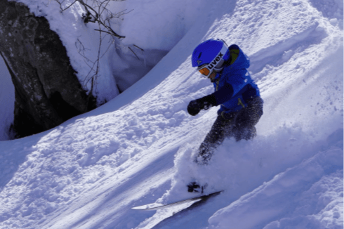 Participants carving through powder snow
