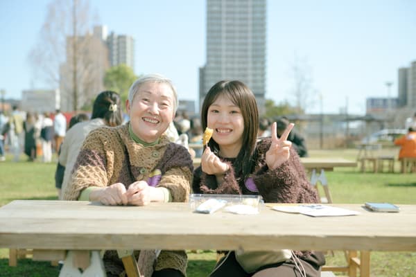 Two visitors enjoying sweet potato