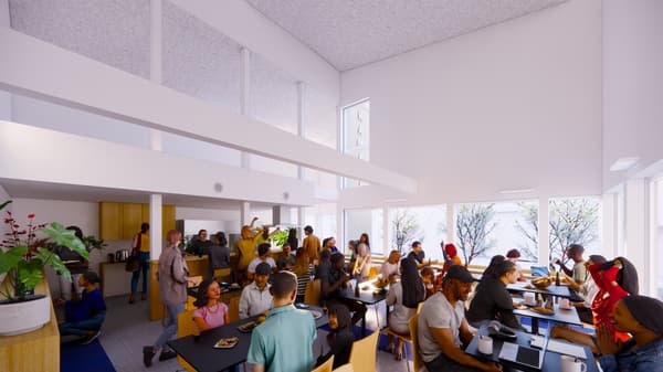 The lounge space with a shared kitchen (rear left), counter seating, and table seating — a welcoming communal area for cooking, conversation, and relaxation.