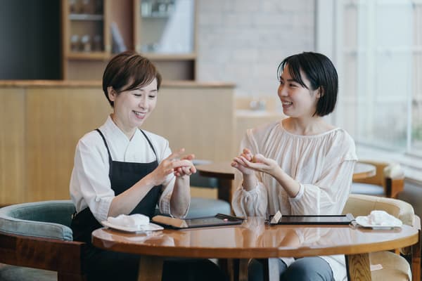 Two people shaping nerikiri by hand at a table