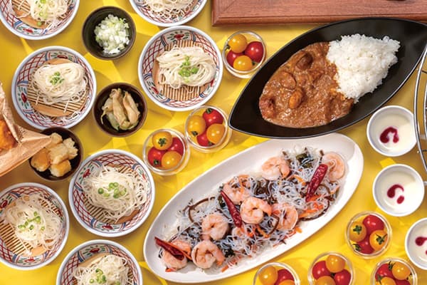 A spread of dishes highlighting Okayama's local produce, including Bisei-cho pork and yellow garlic chives
