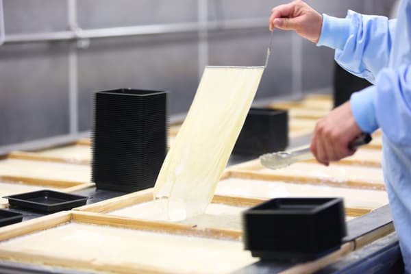 Yuba (tofu skin) being scooped during production