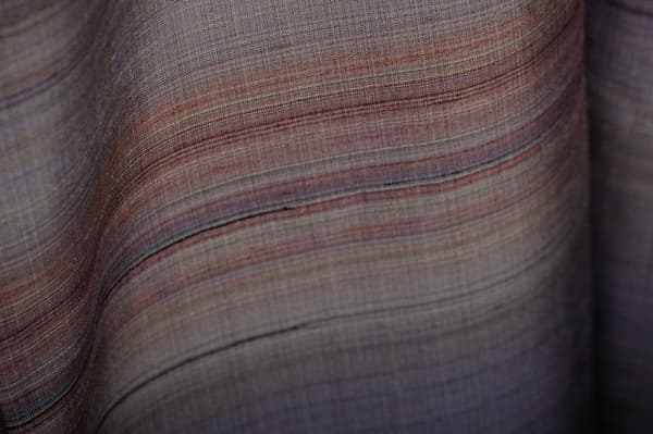 Close-up of handwoven fabric with soft bands of color