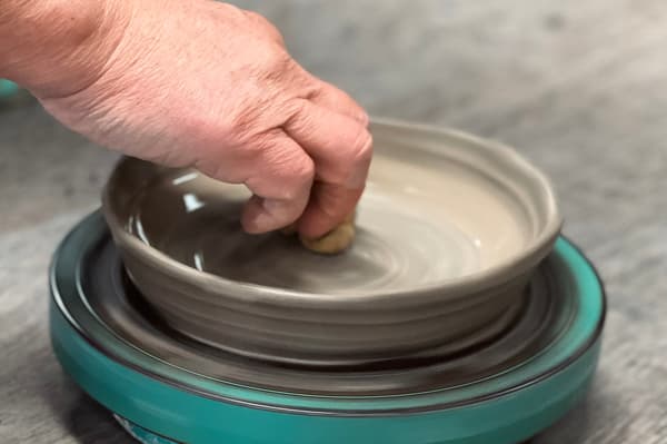 Kneading clay with the kiln master