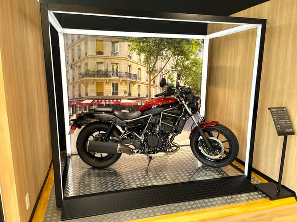 Motorcycles displayed inside the cage