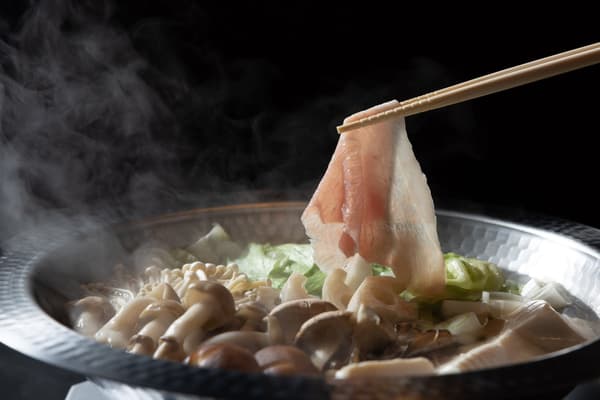 Thin slices of Hayashi SPF Pork passed briefly through the broth, showcasing the texture and sweet fat of each cut