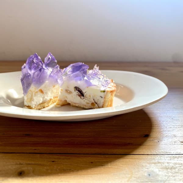 Ricotta cheese and cream base with nuts, chocolate, lemon peel, and raspberry for textural accents