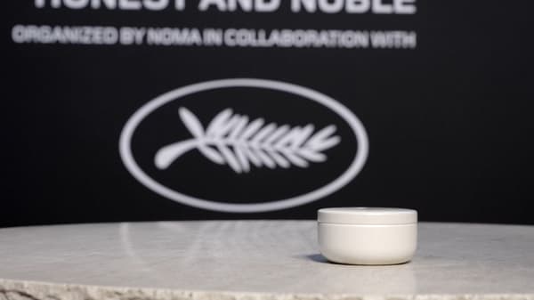 Trinitea tin displayed against a dark event backdrop