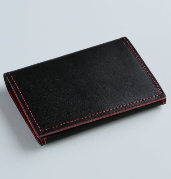 Business card case in black and red, front