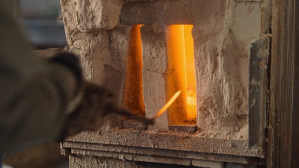 Striking and shaping heated iron at the blacksmith workshop
