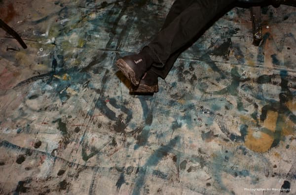 FW26 KEEN x PHILEO collection campaign image of black shoes on a paint-stained floor, photographed by Ari Marcopoulos