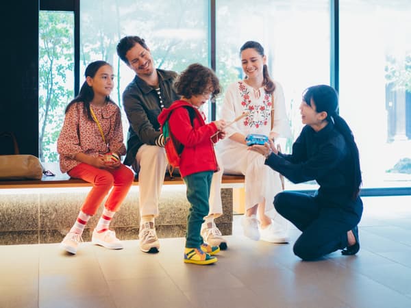 Un miembro del personal hablando con una familia de huéspedes
