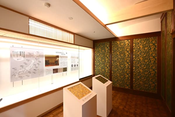 Exhibition room displaying gold leather paper at Kaga Iryokuen