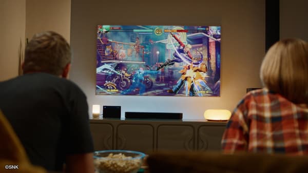 A fighting game match shown on a TV in a living room