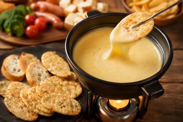 La galleta de arroz local Bakauke de Niigata, sumergida en queso derretido rico y caliente